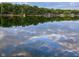 Scenic lake view reflecting the blue sky and clouds, surrounded by lush trees and waterfront homes at 6290 Grouse Dr, Nineveh, IN 46164