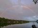 Picturesque lake view with a vibrant rainbow stretching across the sky creating a tranquil setting at 6290 Grouse Dr, Nineveh, IN 46164