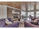 Open concept living room with fireplace and lake views from multiple windows at 6290 Grouse Dr, Nineveh, IN 46164