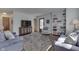 Well-lit living room with hardwood floors, built-in shelving, and cozy seating for relaxing at 6290 Grouse Dr, Nineveh, IN 46164