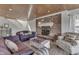 Living room with wood ceiling, brick fireplace, and seating area with lake views at 6290 Grouse Dr, Nineveh, IN 46164