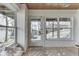 Bright sun room with tiled floors, large windows offering exterior views, and a cozy seating area at 6290 Grouse Dr, Nineveh, IN 46164