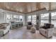Sunroom with lake views, sitting area, tiled floor, wood ceiling and lots of natural light at 6290 Grouse Dr, Nineveh, IN 46164