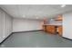 Spacious finished basement with recessed lighting, built-in storage, and epoxy flooring at 6407 Brokenhurst Rd, Indianapolis, IN 46220