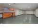 Spacious finished basement with recessed lighting, built-in storage, and epoxy flooring at 6407 Brokenhurst Rd, Indianapolis, IN 46220