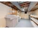 Partially finished basement features utility sink, built-in cabinets, and storage shelves at 6407 Brokenhurst Rd, Indianapolis, IN 46220