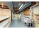 Partially finished basement features utility sink, built-in cabinets, and storage shelves at 6407 Brokenhurst Rd, Indianapolis, IN 46220