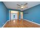 Bedroom featuring hardwood floors, ceiling fan, and closet with folding doors at 6407 Brokenhurst Rd, Indianapolis, IN 46220
