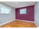 A well-lit bedroom features hardwood floors, neutral walls, and natural light from the window at 6407 Brokenhurst Rd, Indianapolis, IN 46220