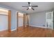 Spacious bedroom with ceiling fan, hardwood floors, closet space, and adjoining bathroom at 6407 Brokenhurst Rd, Indianapolis, IN 46220