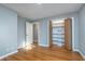 Bright bedroom with gleaming hardwood floors and closet with shelving for ample storage space at 6407 Brokenhurst Rd, Indianapolis, IN 46220