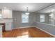 Open dining area with hardwood floors, fresh paint and a view of the kitchen at 6407 Brokenhurst Rd, Indianapolis, IN 46220