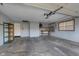 A large, empty two-car garage with ample space for vehicles and storage, featuring shelving and a workbench at 6407 Brokenhurst Rd, Indianapolis, IN 46220