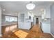 Open concept kitchen with hardwood floors, fresh paint, stainless appliances and white cabinetry at 6407 Brokenhurst Rd, Indianapolis, IN 46220