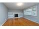 Bright living room with hardwood floors, fireplace, and large windows at 6407 Brokenhurst Rd, Indianapolis, IN 46220