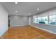 Inviting living room featuring hardwood floors, neutral paint and a large window at 6407 Brokenhurst Rd, Indianapolis, IN 46220