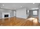 Bright living room with hardwood floors, fireplace, and fresh paint at 6407 Brokenhurst Rd, Indianapolis, IN 46220