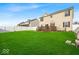 Expansive backyard featuring manicured lawn, a wooden deck, and a pristine white fence, perfect for outdoor living at 6862 School Branch Dr, Brownsburg, IN 46112