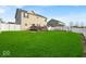 Large backyard with lush green lawn, a deck, and a white fence providing privacy and space for outdoor enjoyment at 6862 School Branch Dr, Brownsburg, IN 46112