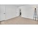 Bedroom featuring plush carpeting, a modern floor lamp, and an adjacent laundry area at 6862 School Branch Dr, Brownsburg, IN 46112