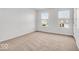 Bright bedroom featuring neutral carpeting, two large windows, and ample natural light at 6862 School Branch Dr, Brownsburg, IN 46112