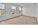 Bedroom with neutral carpet, two large windows bringing in natural light, and painted in a neutral color at 6862 School Branch Dr, Brownsburg, IN 46112