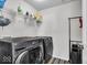 Laundry room with front-load washer and dryer and shelving for storage at 6862 School Branch Dr, Brownsburg, IN 46112