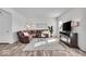 Comfortable living room featuring wood floors, sectional sofa, television, and modern decor at 6862 School Branch Dr, Brownsburg, IN 46112