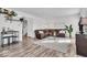 Bright living room featuring wood floors, a leather sectional, and modern decor accents at 6862 School Branch Dr, Brownsburg, IN 46112