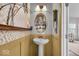 Charming powder room featuring pedestal sink, elegant mirror, and stylish decorative accents at 6862 School Branch Dr, Brownsburg, IN 46112
