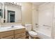 Neutral toned bathroom featuring a single sink vanity with a large, well-lit mirror, toilet, and shower with a tub at 7616 Newport Bay E Dr, Indianapolis, IN 46240