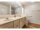A neutral bathroom with double vanity sinks, a large mirror, and a walk-in shower at 7616 Newport Bay E Dr, Indianapolis, IN 46240