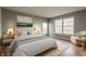 A beautifully furnished bedroom with cozy decor, natural light, and a comfortable chair at 7616 Newport Bay E Dr, Indianapolis, IN 46240