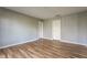 An empty bedroom featuring hardwood floors, a double closet, and a bright window at 7616 Newport Bay E Dr, Indianapolis, IN 46240
