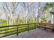Spacious wooden deck surrounded by a forest view, offering an ideal outdoor living space at 7616 Newport Bay E Dr, Indianapolis, IN 46240