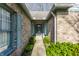 Inviting entryway with brick facade, front door, and lush landscaping along the walkway at 7616 Newport Bay E Dr, Indianapolis, IN 46240
