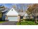 Charming single-story home with brick facade, light blue accents, and an attached two-car garage at 7616 Newport Bay E Dr, Indianapolis, IN 46240