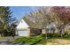 Charming single-story home with brick facade, light blue accents, and a well-manicured front yard at 7616 Newport Bay E Dr, Indianapolis, IN 46240