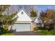 Single-story home with brick facade, light blue accents, two-car garage, and well-manicured lawn at 7616 Newport Bay E Dr, Indianapolis, IN 46240