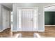 Bright foyer with hardwood floors, white front door with sidelights, and views into other rooms at 7616 Newport Bay E Dr, Indianapolis, IN 46240