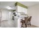 Well-equipped kitchen with bar seating and views into dining and laundry areas at 7616 Newport Bay E Dr, Indianapolis, IN 46240