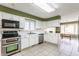 Well-lit kitchen featuring white cabinets, stainless steel appliances, and tile floors at 7616 Newport Bay E Dr, Indianapolis, IN 46240