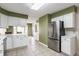 Modern kitchen with stainless steel appliances and views into the eat-in area at 7616 Newport Bay E Dr, Indianapolis, IN 46240