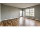 A spacious living room with wood floors, natural light, and a sliding door to the outside at 7616 Newport Bay E Dr, Indianapolis, IN 46240