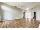 Open living room with neutral walls, wood floors, and a ceiling fan at 7616 Newport Bay E Dr, Indianapolis, IN 46240