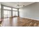Bright and airy living room featuring sliding glass doors, a fireplace, and hardwood floors at 7616 Newport Bay E Dr, Indianapolis, IN 46240