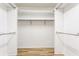 A large empty walk-in closet with built-in shelving and wood floors at 7616 Newport Bay E Dr, Indianapolis, IN 46240