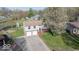 Aerial view of a two-story home with an attached garage and tree-lined lot at 7733 Opelika Ct, Indianapolis, IN 46217