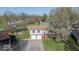 Aerial view showcases the home's setting with mature trees and a two-car garage at 7733 Opelika Ct, Indianapolis, IN 46217