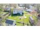Aerial view of the house and large backyard with shed and mature trees at 7733 Opelika Ct, Indianapolis, IN 46217